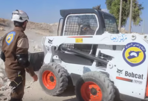 Du matériel "made in USA": les casques Blancs étrennent leur pelleteuse Bobcat (entreprise US) toute neuve à Idlib, à la frontière turque - capture d'écran d'une vidéo promotionnelle des Casques Blancs